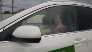 A student begins her driving lesson behind the wheel.