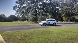 A student begins his driving lesson in the parking lot.