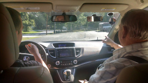 Mr. Sabbadino explains a driving exercise to his student.