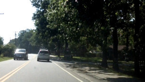 A student drives down a two-lane road in the drivers education car with Mr. Sabbadino.