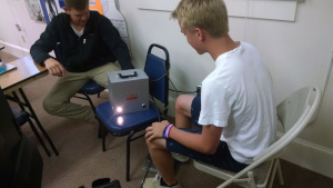 Students test their reflexes on a machine that simulates pressing the brake pedal in a car.