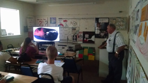 Mr. Sabbadino shows the class a video.